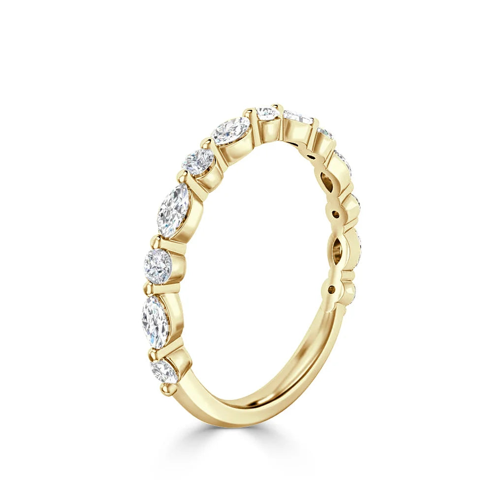 Gold ring with alternating marquise and round diamonds set along half of the band, shown on a white background.
