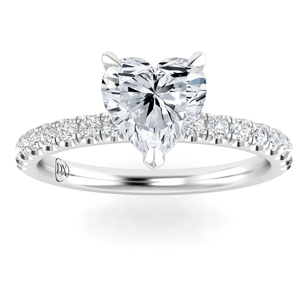 Heart-shaped diamond ring with a pavé band set in white metal, shown on a white background.