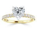A gold ring with a heart-shaped diamond center stone and small round diamonds along the band.