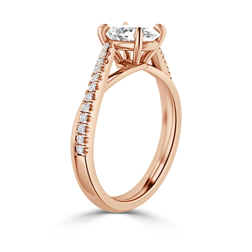 Rose gold ring with a round-cut diamond center stone and small accent diamonds on the band.