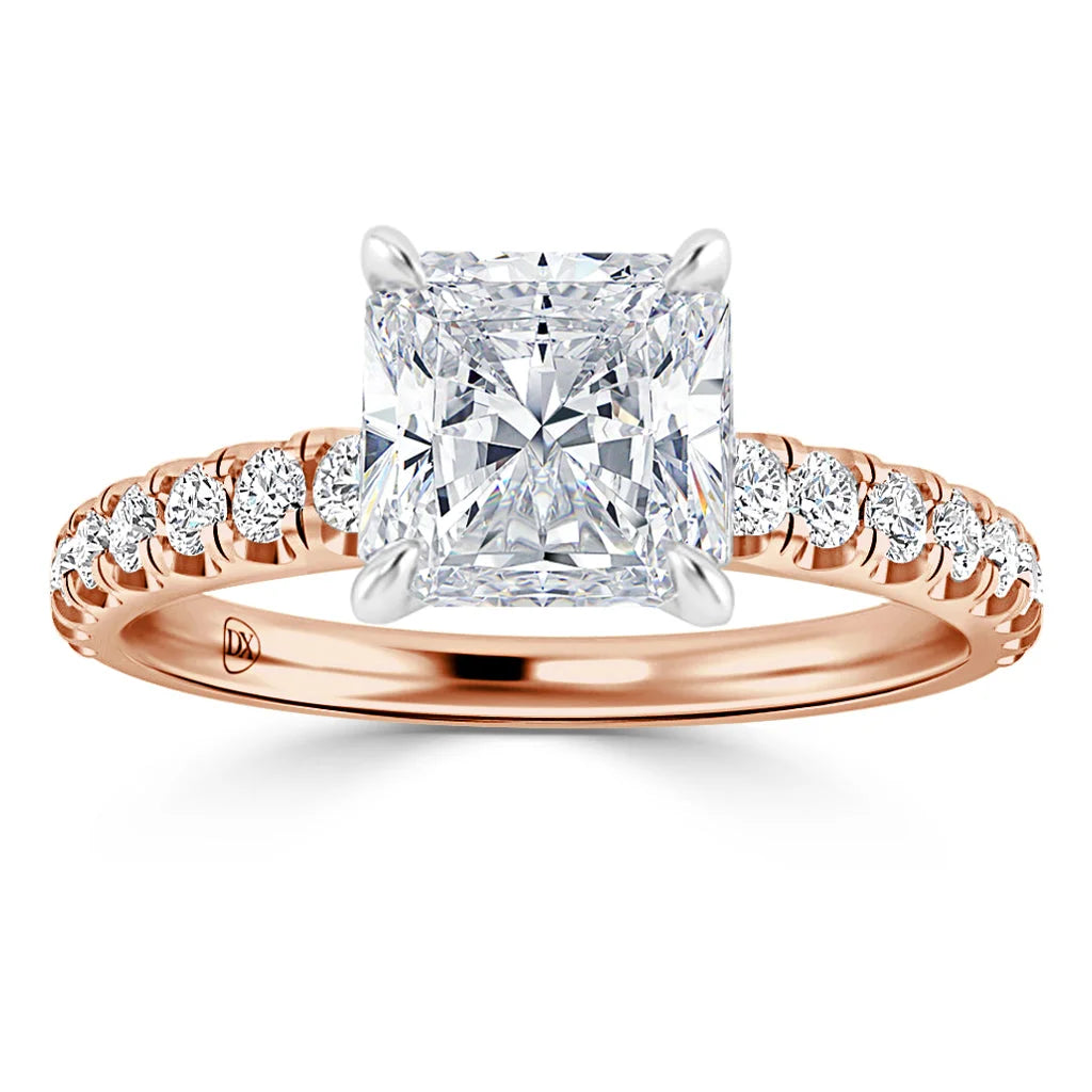 Rose gold ring with a large square diamond and smaller diamonds along the band, seen from the front.