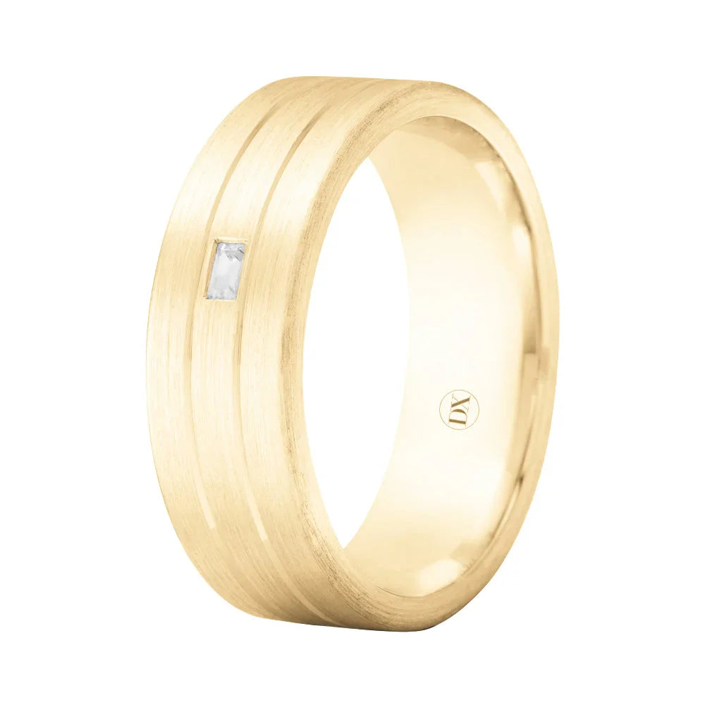 Gold ring with a brushed finish, a single rectangular diamond, and two parallel engraved lines.