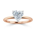A rose gold ring with a heart-shaped diamond solitaire set in a simple, elegant prong setting.