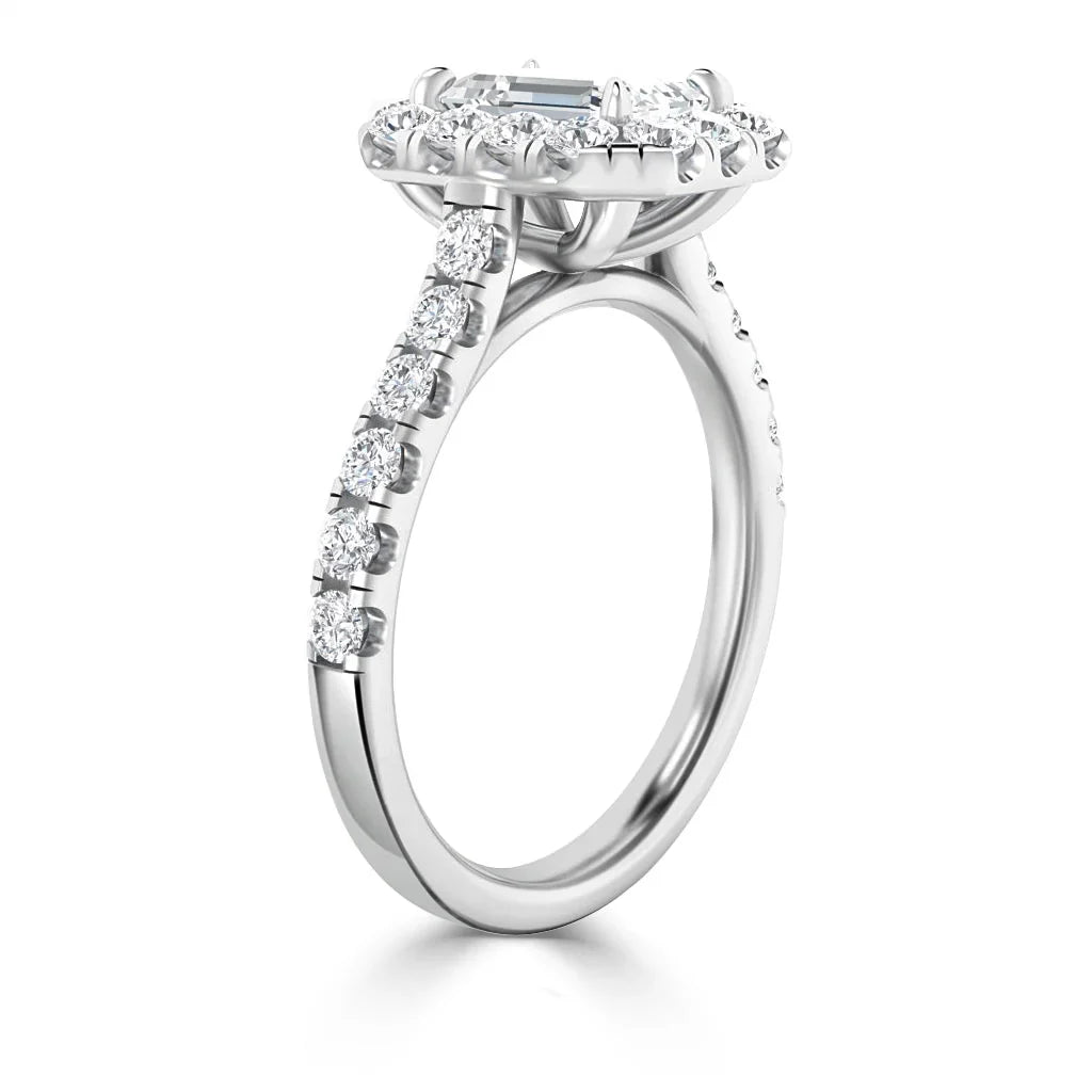 White gold engagement ring with a halo setting and diamonds along the band, viewed from the side.