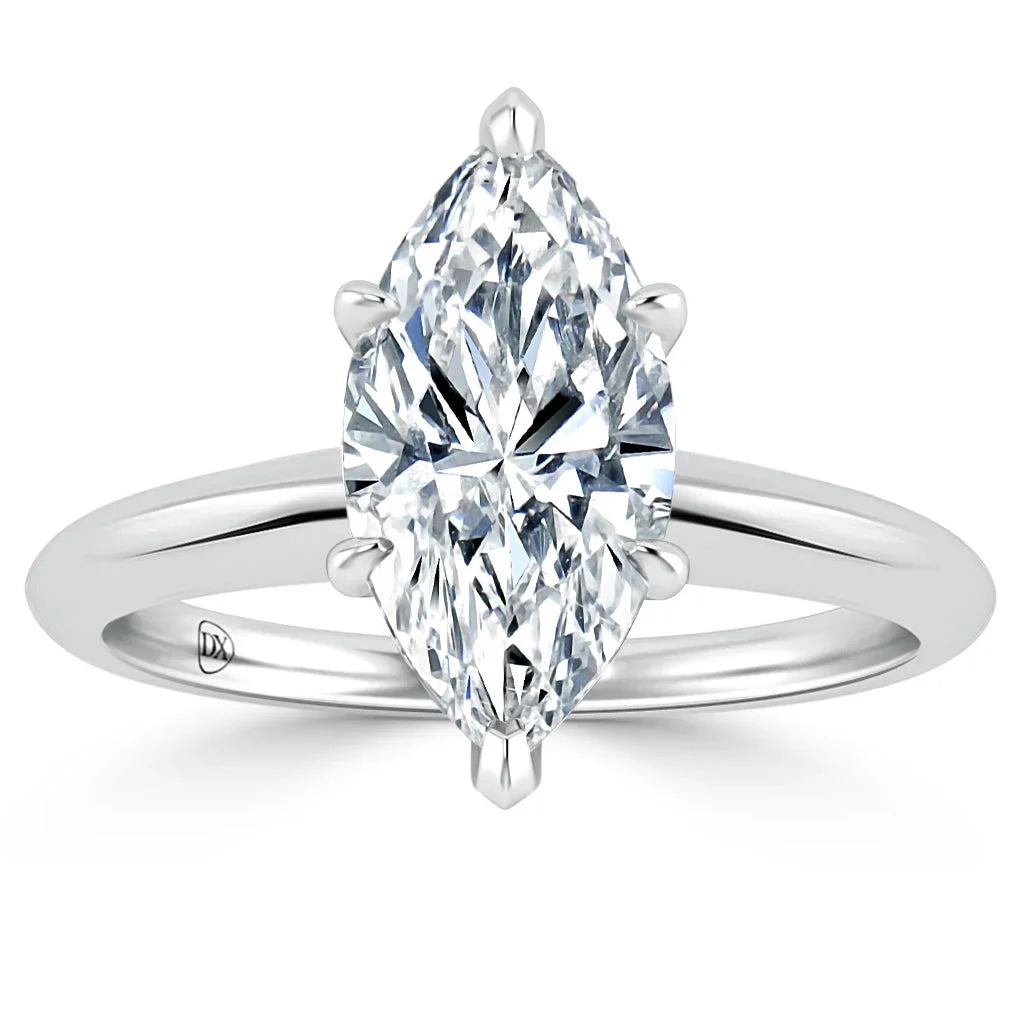 A marquise-cut diamond solitaire ring with a simple, polished platinum band, shown on a white background.