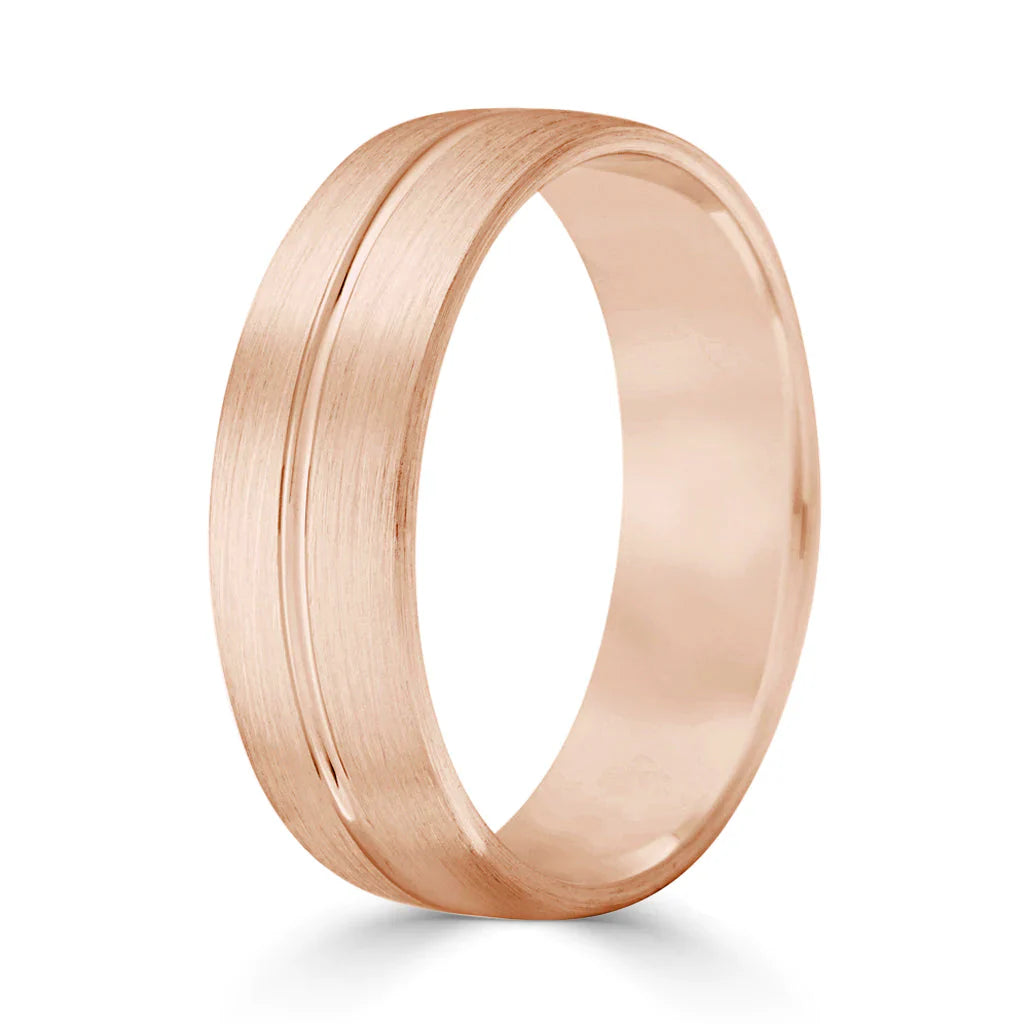 Rose gold ring with a brushed finish and a single engraved line circling the band.