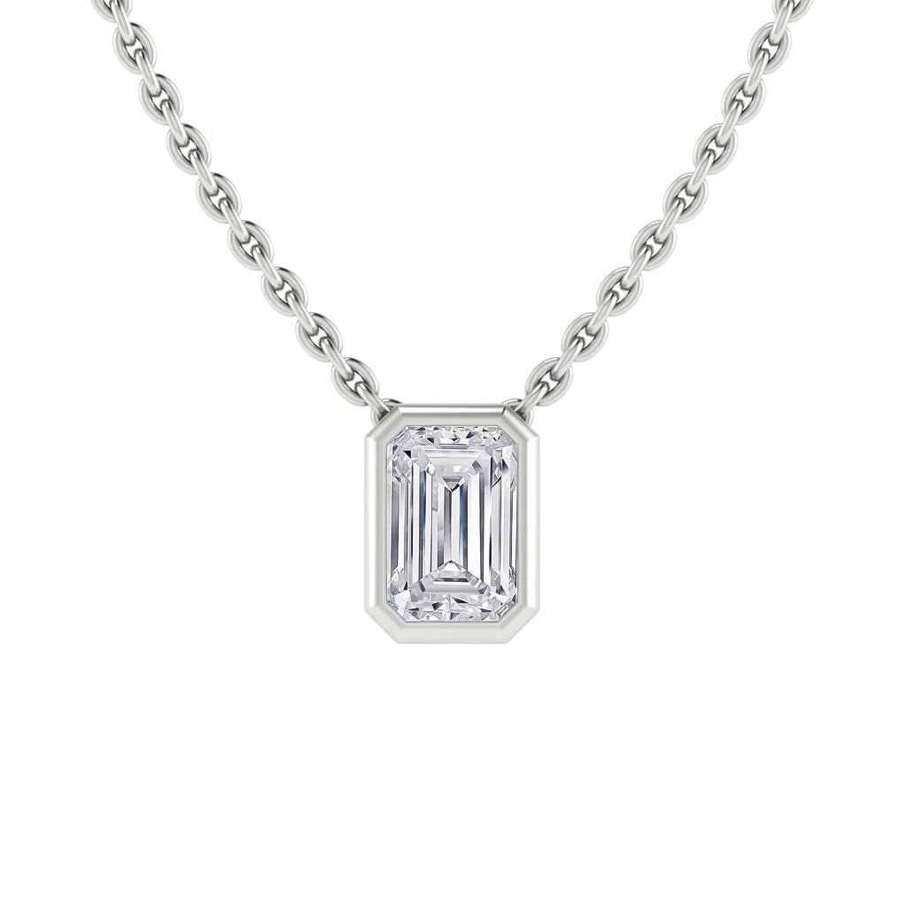 A silver chain necklace with a rectangular emerald-cut diamond pendant in a simple bezel setting.