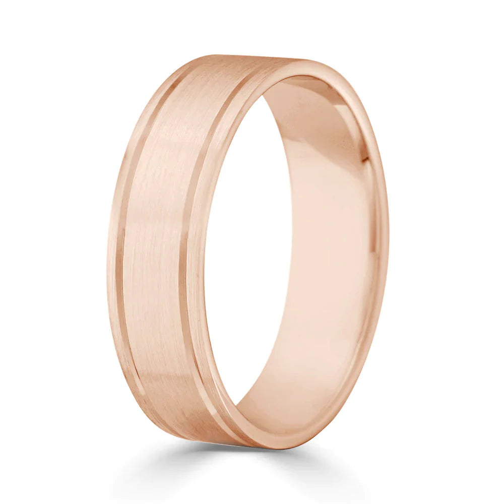 A brushed rose gold ring with a simple, flat design and a subtle groove near one edge.
