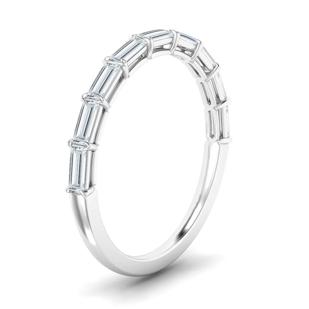 A thin silver ring with rectangular baguette-cut diamonds set along the upper half of the band.