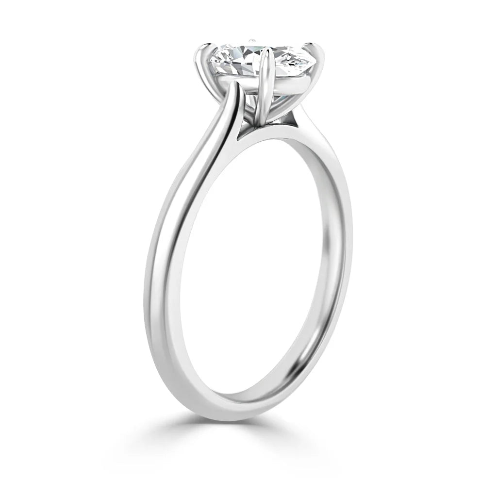 Side view of a platinum solitaire engagement ring with a round brilliant-cut diamond in a prong setting.