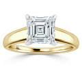 A gold band ring with a large, square, asscher-cut diamond set in a four-prong white gold setting.