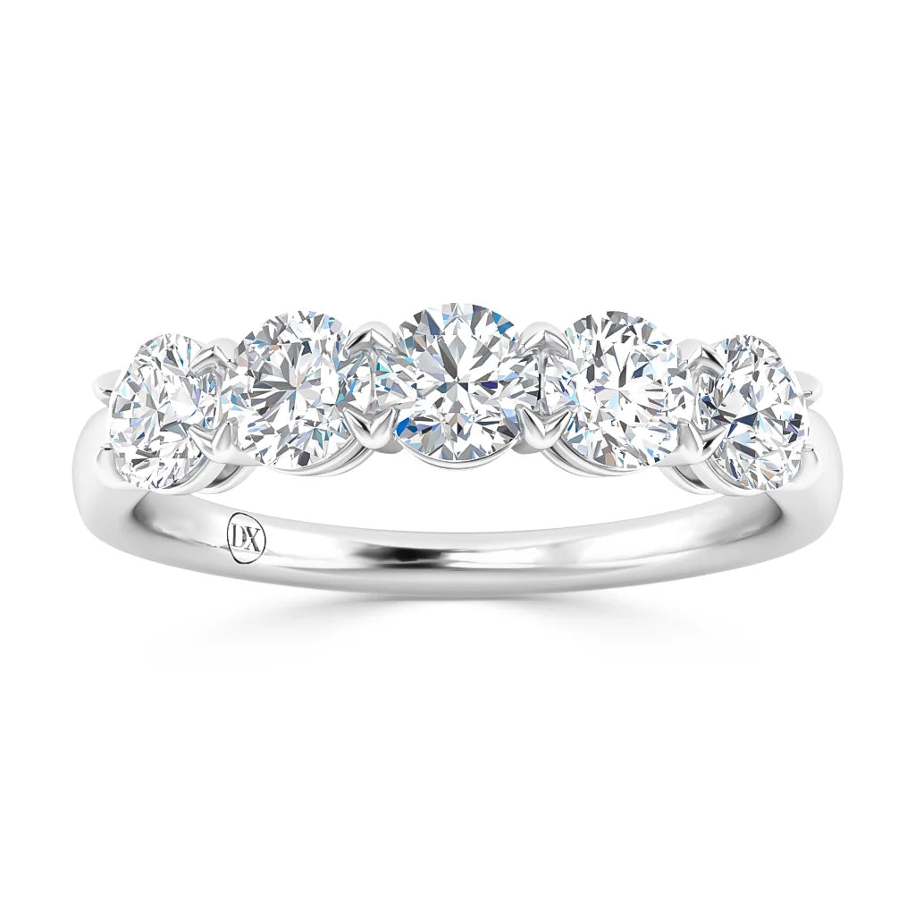 A silver ring with five round, sparkling diamonds set in a row on the band.
