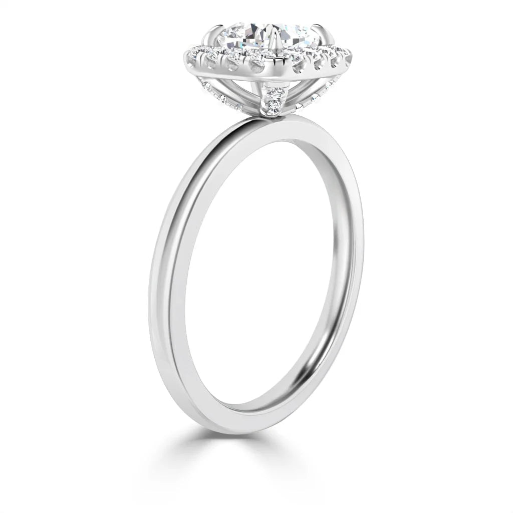 Side view of a silver ring with a large round diamond and a detailed, raised halo setting.