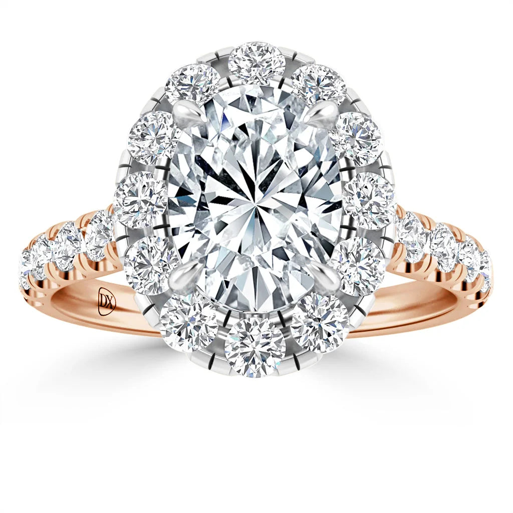 Rose gold ring with large oval diamond center, surrounded by halo of smaller diamonds and diamond-accented band.