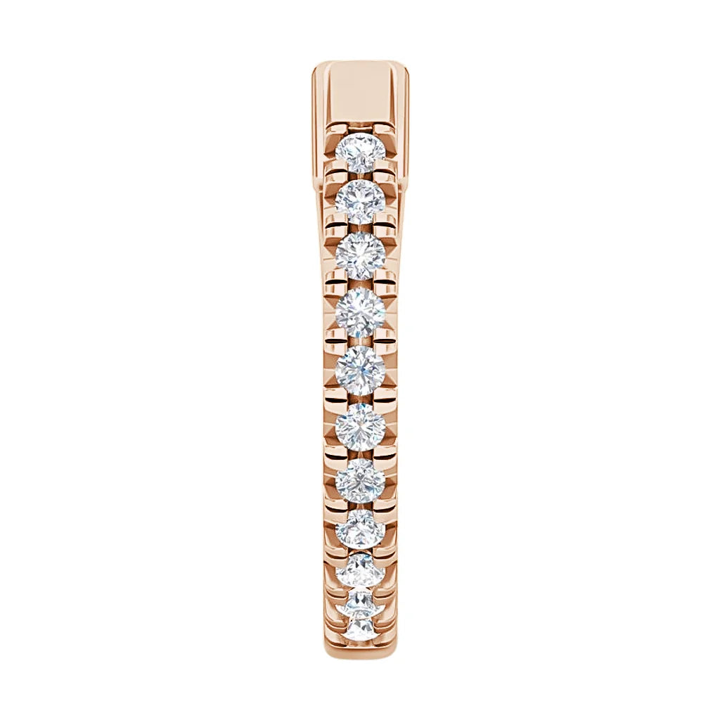A rose gold ring with a row of round white diamonds set in a straight line on the band.