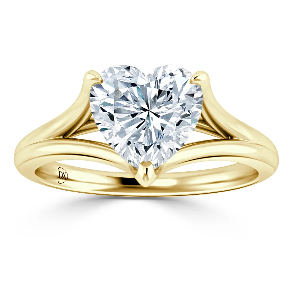A gold ring with a heart-shaped diamond solitaire and a split shank band, shown on a white background.