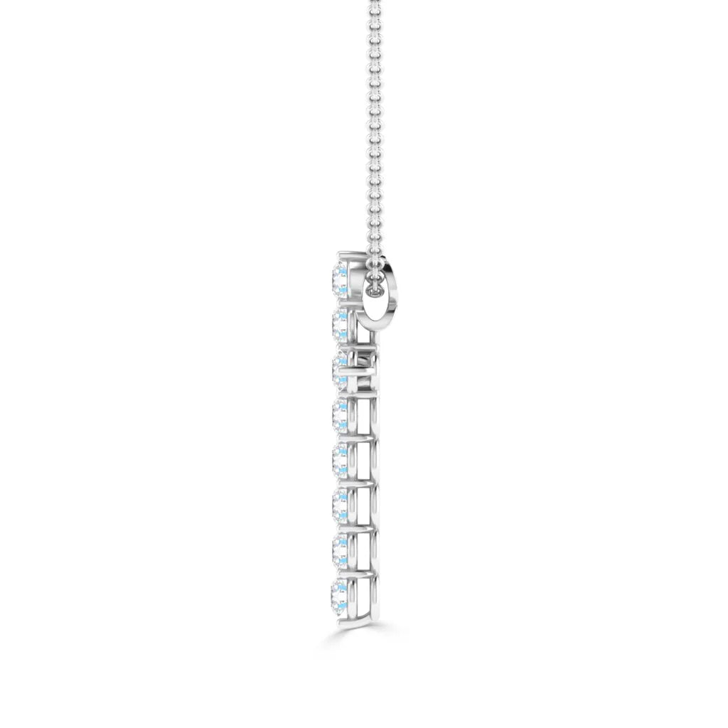 A vertical silver pendant with nine round white gemstones, hanging from a thin chain, on a white background.