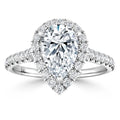 Pear-shaped diamond ring with a halo of smaller diamonds on a diamond-studded white gold band.