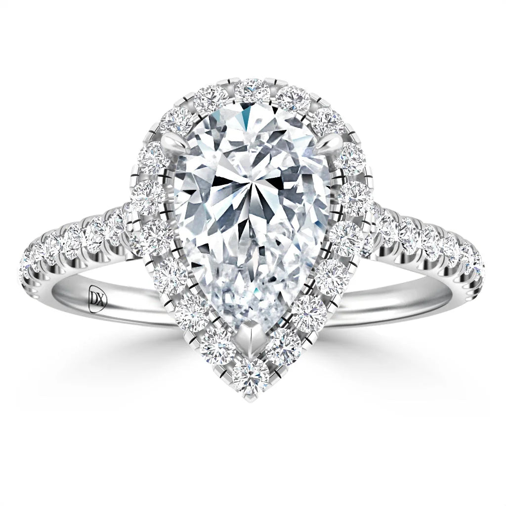 Pear-shaped diamond ring with a halo of smaller diamonds on a diamond-studded white gold band.