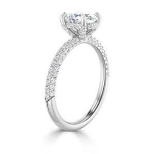 A white gold pavé diamond engagement ring with a large round center stone in a raised prong setting.