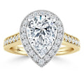 Pear-shaped diamond ring with a halo setting and diamond-accented gold band, shown on a white background.