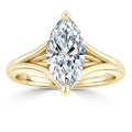 A marquise-cut diamond ring with a split yellow gold band, shown on a white background.