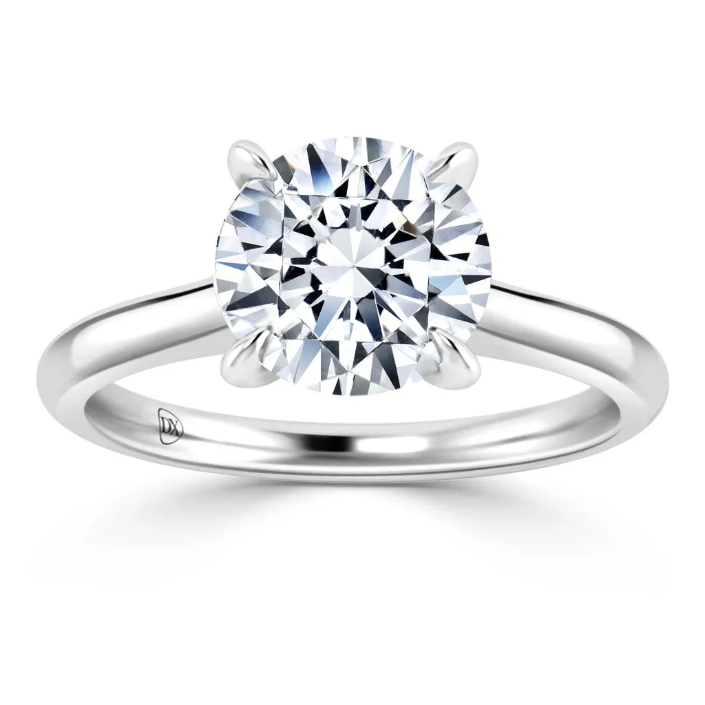 A silver band solitaire ring with a large, round-cut diamond set in a four-prong setting.