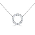A silver chain necklace with a circular pendant encrusted with small, sparkling diamonds on a white background.