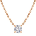 A gold chain necklace with a single round diamond pendant set in a minimalist prong setting.