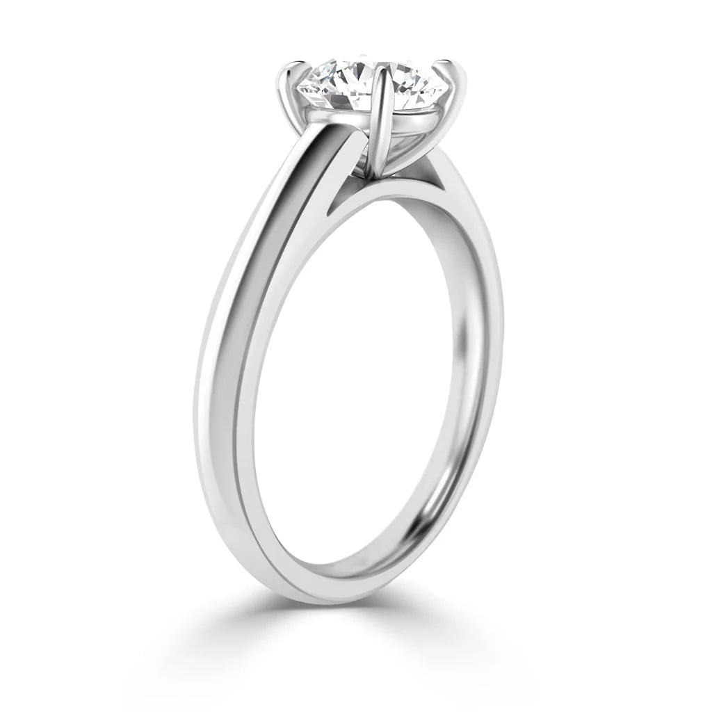 A solitaire diamond ring with a round brilliant cut diamond in a four-prong white gold setting.