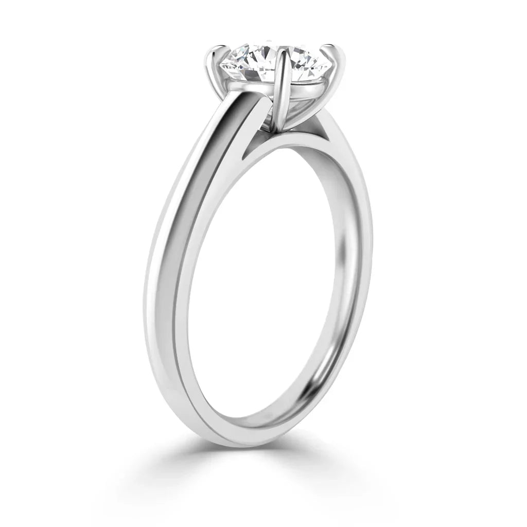 A solitaire diamond ring with a round brilliant cut diamond in a four-prong white gold setting.