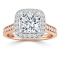 A cushion-cut diamond ring with a halo and side stones on a rose gold band with intricate detailing.