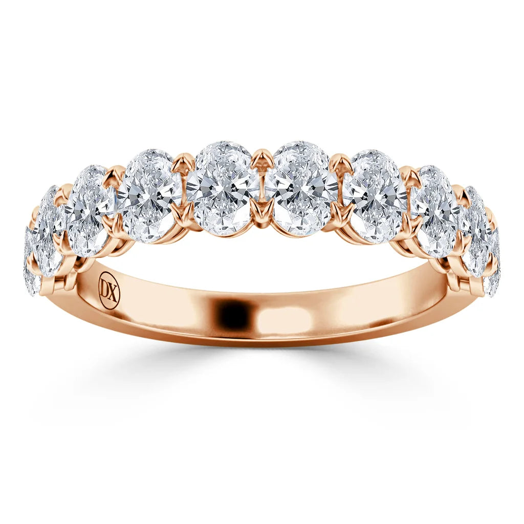 A rose gold ring with a row of round, brilliant-cut diamonds set across the band.