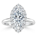 Marquise-cut diamond ring with a halo of small diamonds set on a polished white gold band.
