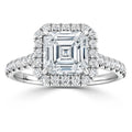 Asscher-cut diamond ring with a halo of smaller diamonds on a diamond-studded white gold band.