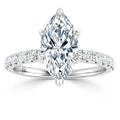A marquise-cut diamond ring with a pavé diamond band, set in polished white metal, on a white background.