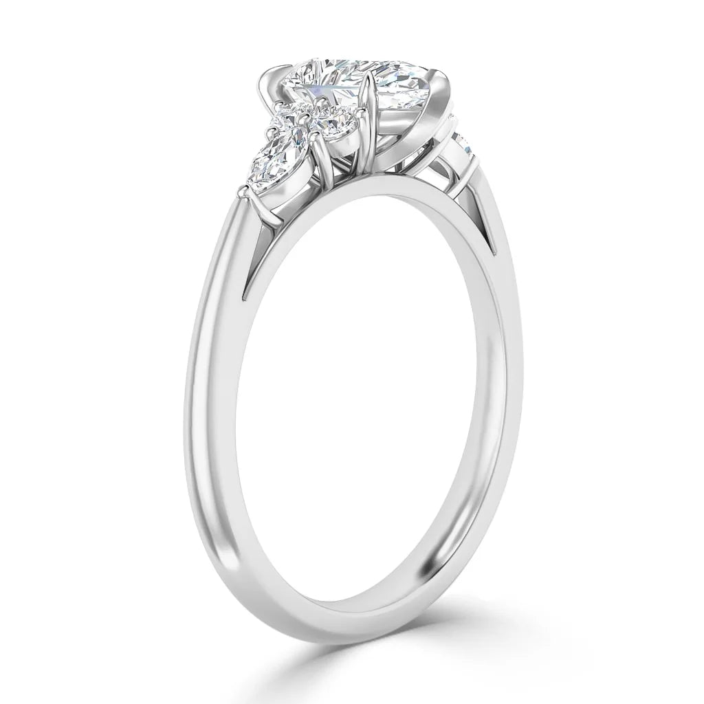 Side view of a white gold ring with a large round center diamond and two smaller round diamonds on each side.