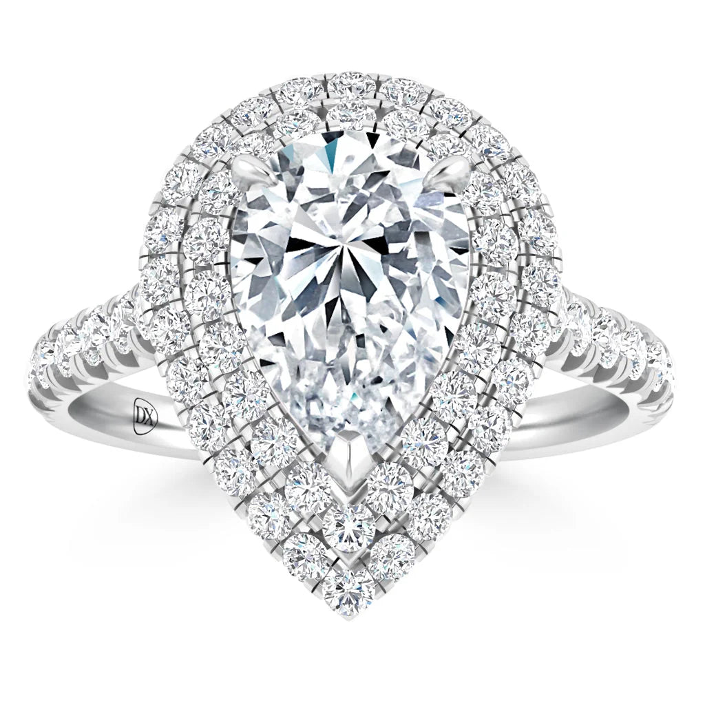 Pear-shaped diamond ring with double halo and pavé band, all set in white metal, sparkling brightly.