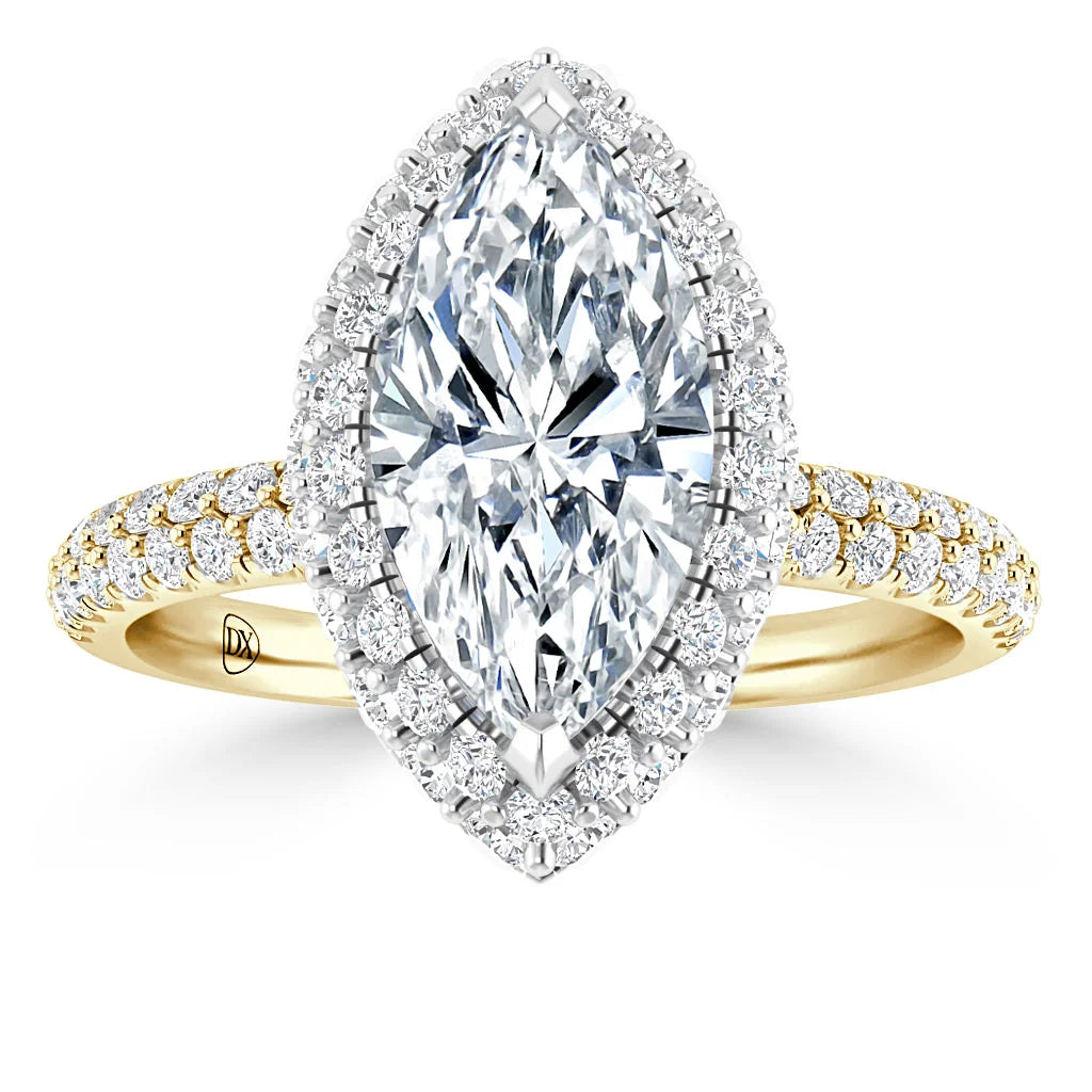 A marquise-cut diamond ring with a double halo and pavé diamonds on a yellow gold band.