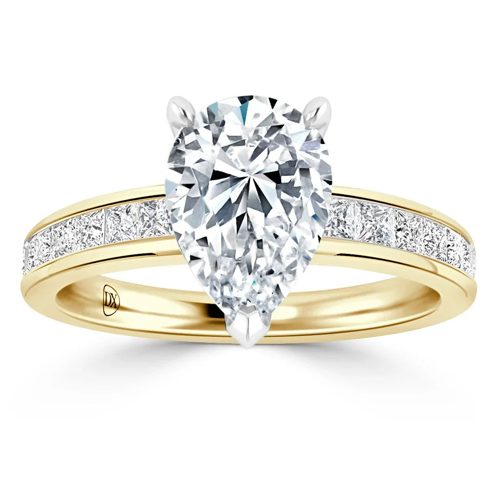 A gold ring with a large pear-shaped diamond center and smaller diamonds set along the band.
