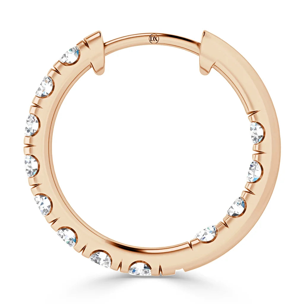 Rose gold hoop earring with evenly spaced round white gemstones set along the outer edge.