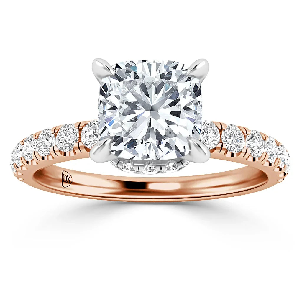 Rose gold ring with a large cushion-cut diamond center and smaller diamonds along the band.