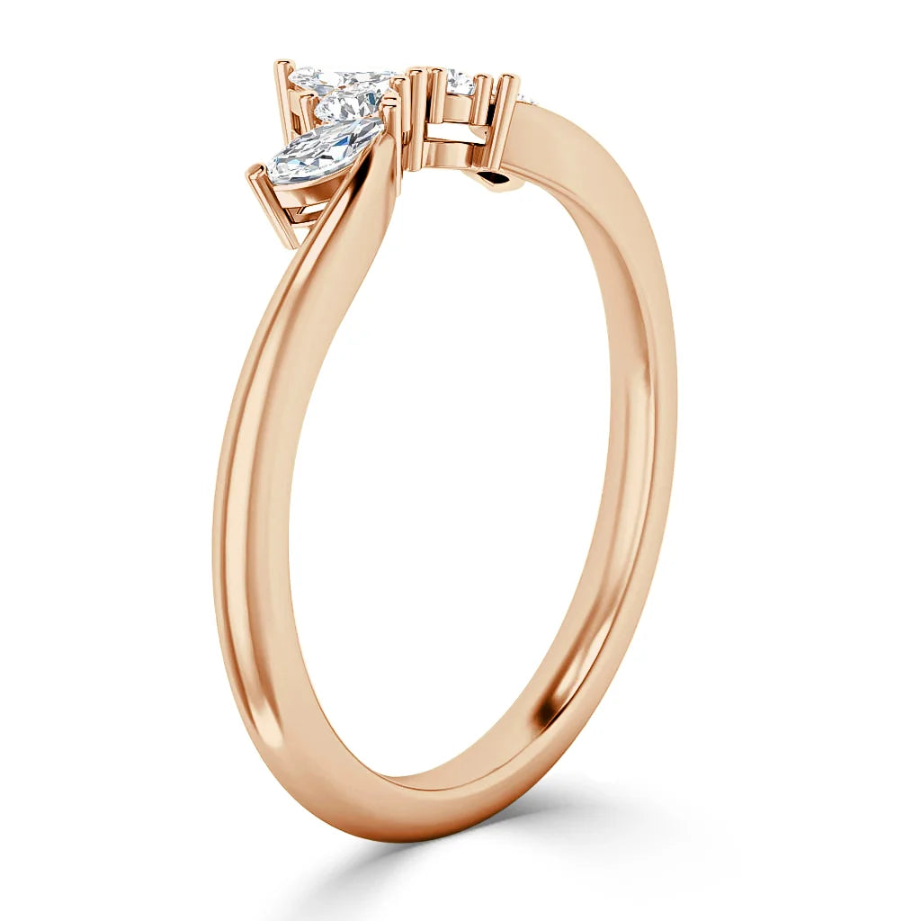 Rose gold ring with two marquise-cut diamonds set in a bypass design, viewed from an angled side.