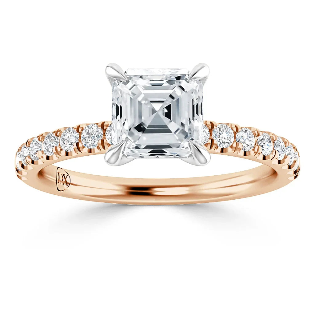 A rose gold ring with a square-cut diamond center stone and small diamonds on the band.