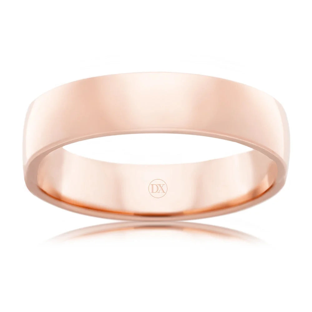 A plain, polished rose gold wedding band with a smooth surface and a small DX logo inside.