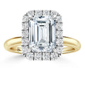 Gold ring with a large emerald-cut diamond, surrounded by a halo of smaller round diamonds.