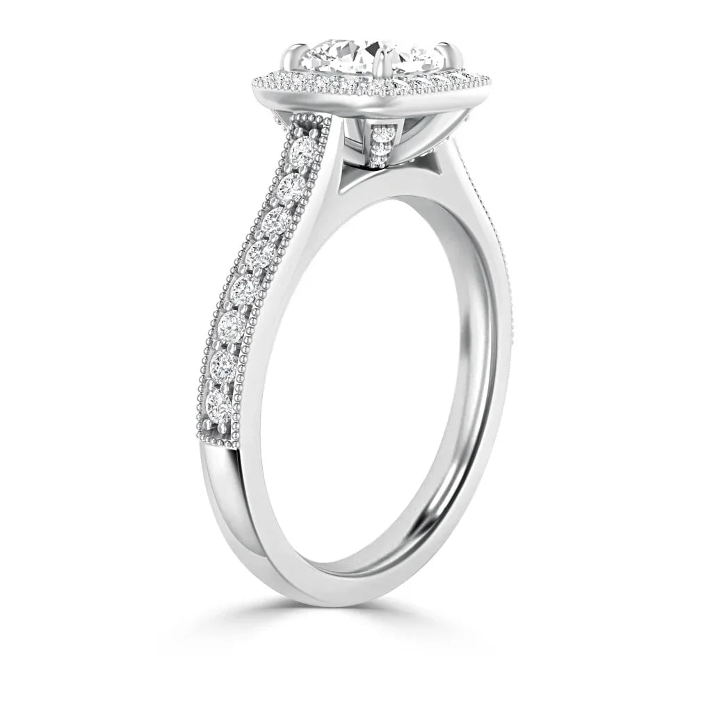 White gold ring with pavé diamonds along the band and a round center diamond in a raised prong setting.
