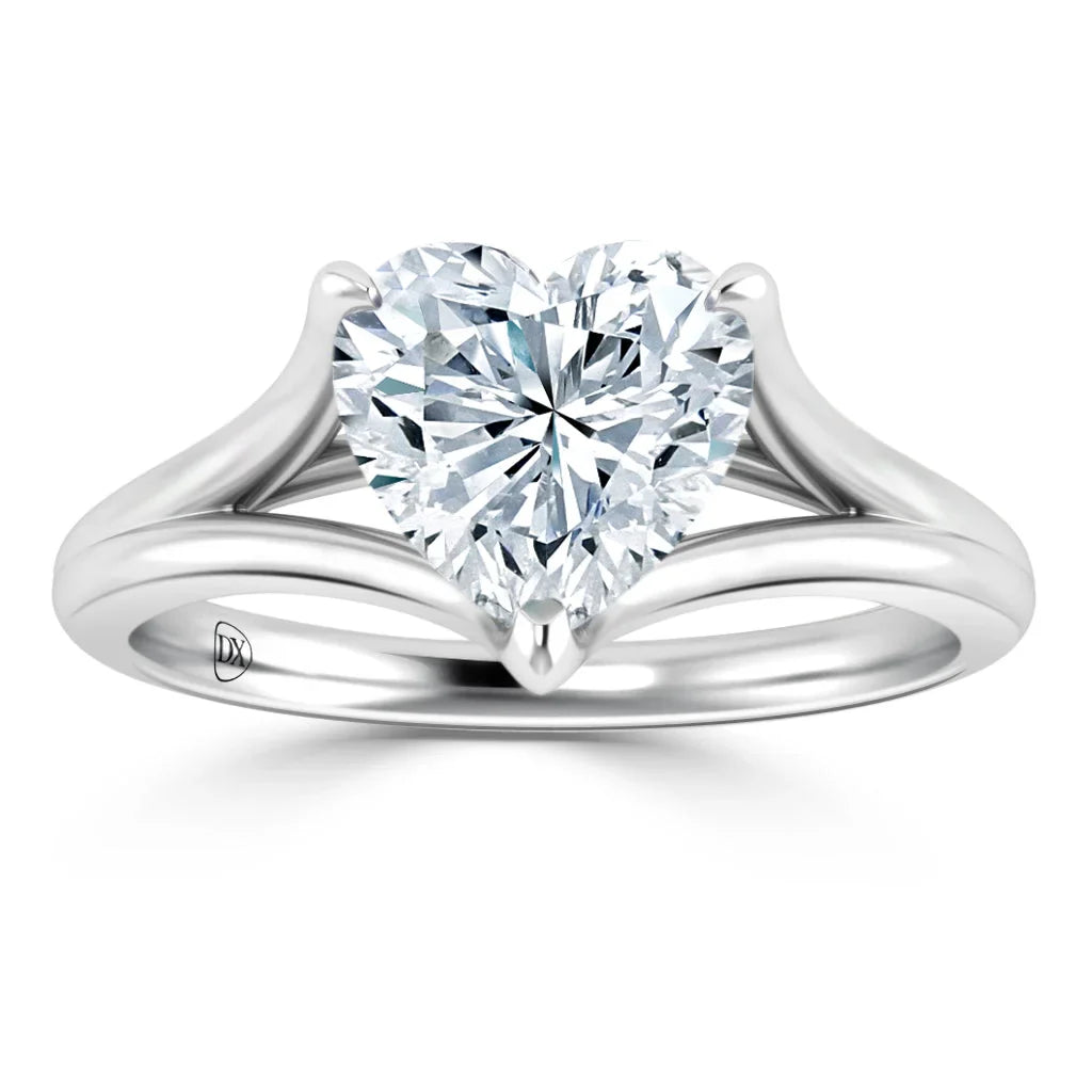 Platinum ring with a heart-shaped diamond solitaire and a split shank band, set against a white background.