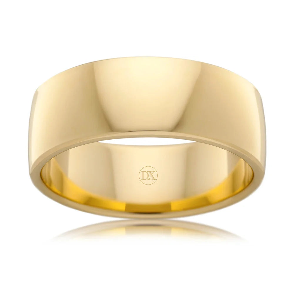 A polished, plain yellow gold ring with smooth edges and a DX engraving inside the band.