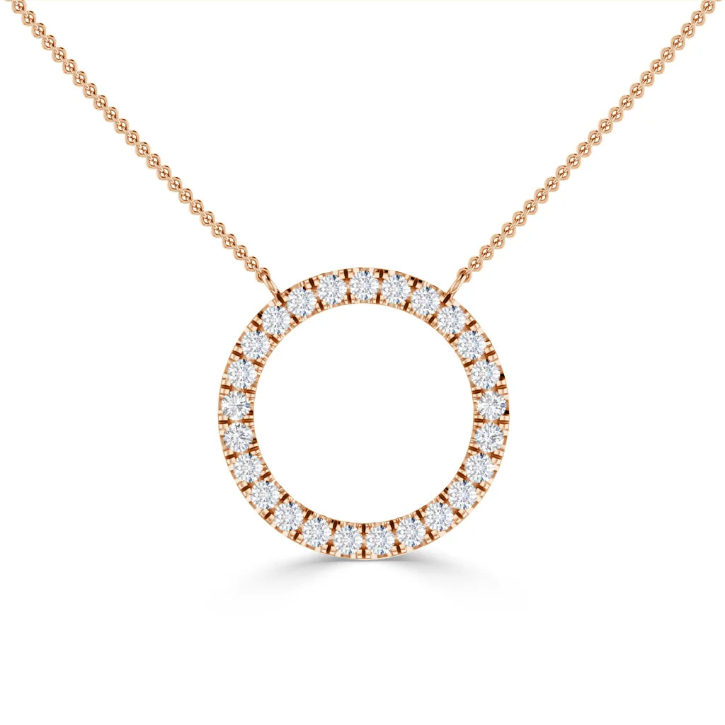 Gold necklace with a circular pendant encrusted with small, sparkling diamonds on a fine chain.
